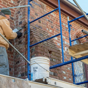 Preservationist on scaffold restores Memorial Church brickwork