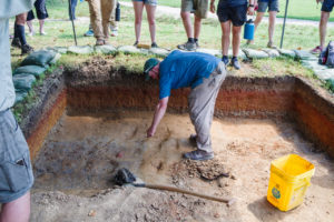 Senior Staff Archaeologist Sean Romo discusses the burial site excavations with the Field School students.