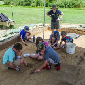 Staff Archaeologist Natalie Reid watches as campers conduct excavations north of James Fort.