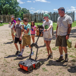Campers learning how to use the GPR with Director of Archaeology David Givens.