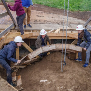 Archaeologists Natalie Reid, Gabriel Brown, and Anna Shackelford dismantle the well ring prior to the backfilling of the Governor's Well.