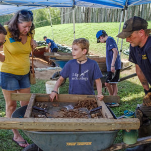 A camper shares his finds with some visitors.