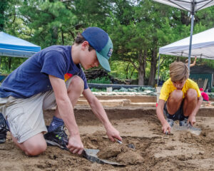Two campers excavate at the clay borrow pit