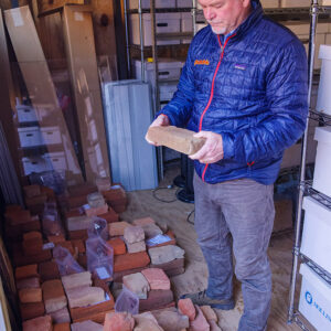 Director of Archaeology David Givens examines one of the bricks found in the Governor's Well.