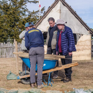Staff Archaeologist Natalie Reid shares her finds with visitors as she screens soil from the excavations west of the Church Tower.