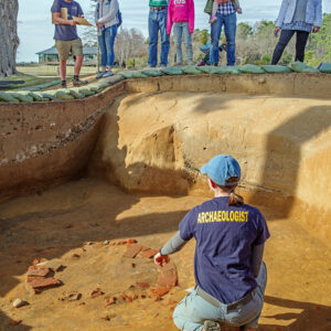 Staff Archaeologist Natalie Reid and Archaeological Field Technician Josh Barber share the well excavations with visitors.
