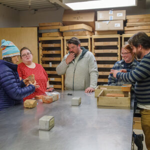 (L-R) Senior Staff Archaeologist Mary Anna Hartley, Collections Assistant Lauren Stephens, and Colonial Williamsburg's Journeyman of Masonry Trades Kenneth Tappan, Brickmaker's Apprentice Madeleine Bolton, and Masonry Trades Manager Josh Graml discuss some of the bricks from the Governor's Well.