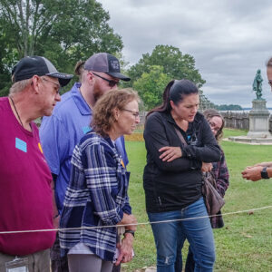 Senior Staff Archaeologist Anna Shackelford shares an artifact found at the 1607 Burial Ground with visitors.