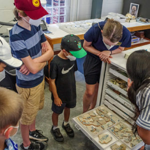 Assistant Curator Emma Derry shares the Jamestown Rediscovery's delft tile collection with campers.