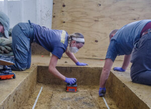 Archaeological Field Technician Katie Griffith and Director of Archaeology Sean Romo conduct a ground-penetrating radar (GPR) survey of the burial in Smithfield.
