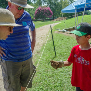A camper shares a find with visitors.