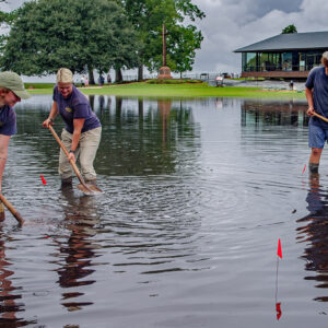 Archaeological Field Technician Ren Willis, Staff Archaeologist Caitlin Delmas, and Archaeological Field Technician Josh Barber are finding excavations at Smithfield difficult after a flood.