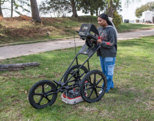 A Surry County High School student conducts a ground-penetrating radar (GPR) survey of an area north of Fort Pocahontas.