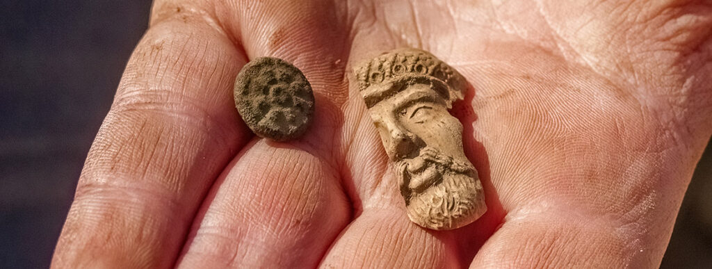 A button and a partial Turk's head pipe found at the Godspeed Cottage excavations