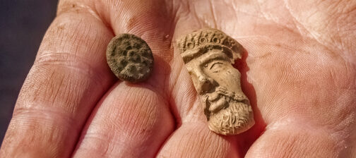 A button and a partial Turk's head pipe found at the Godspeed Cottage excavations