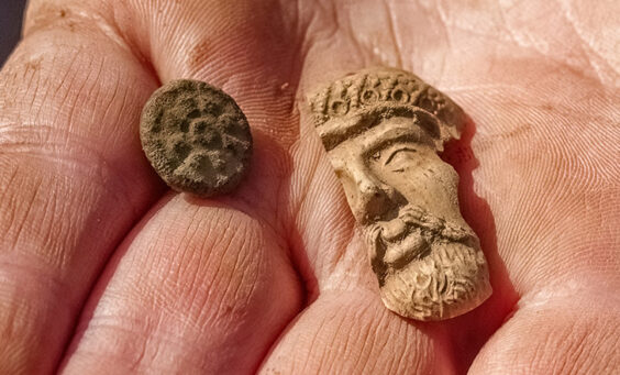 A button and a partial Turk's head pipe found at the Godspeed Cottage excavations