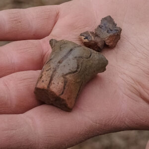 A sherd of sgraffito ceramic likely part of a vessel's handle