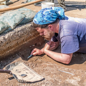 Archaeological Field Technician Josh Barber searches for more pieces of the slate.