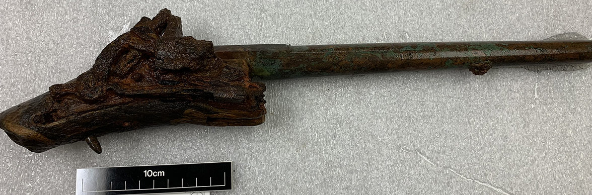conserved pistol with corroded stock