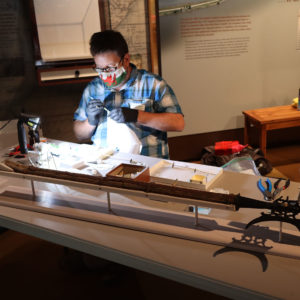 Conservator Dr. Chris Wilkins prepares artifacts for the "Gentleman Soldiers" exhibit
