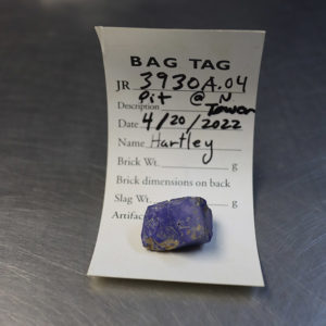 Blue glass found in the north Church Tower excavations. This may be an ingot of glass or the byproduct of glass production.