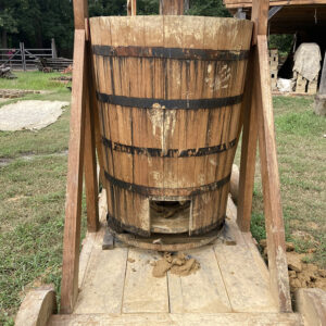 The wooden mixer portion of Colonial Williamsburg's pug mill. Clay is fed from the top and the refined clay comes out of the square hole at the bottom.