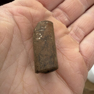 A decorated pipe stem made of Virginia clay found in the excavations outside the Church Tower