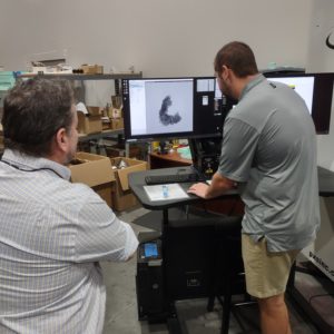 Pinnacle's Jake Rickter shares an X-ray of chain armor with Conservator Dr. Chris Wilkins.