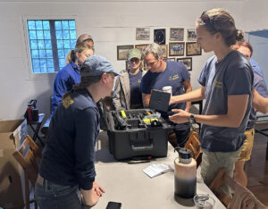 The archaeology staff examines a new ground-penetrating radar machine with a 1500 MHz antenna. Last year the team achieved the best results of burials from GPR surveys using a loaned machine with the same frequency antenna. This new machine was a gift from long-time Jamestown benefactor CarolAnn Babcock.