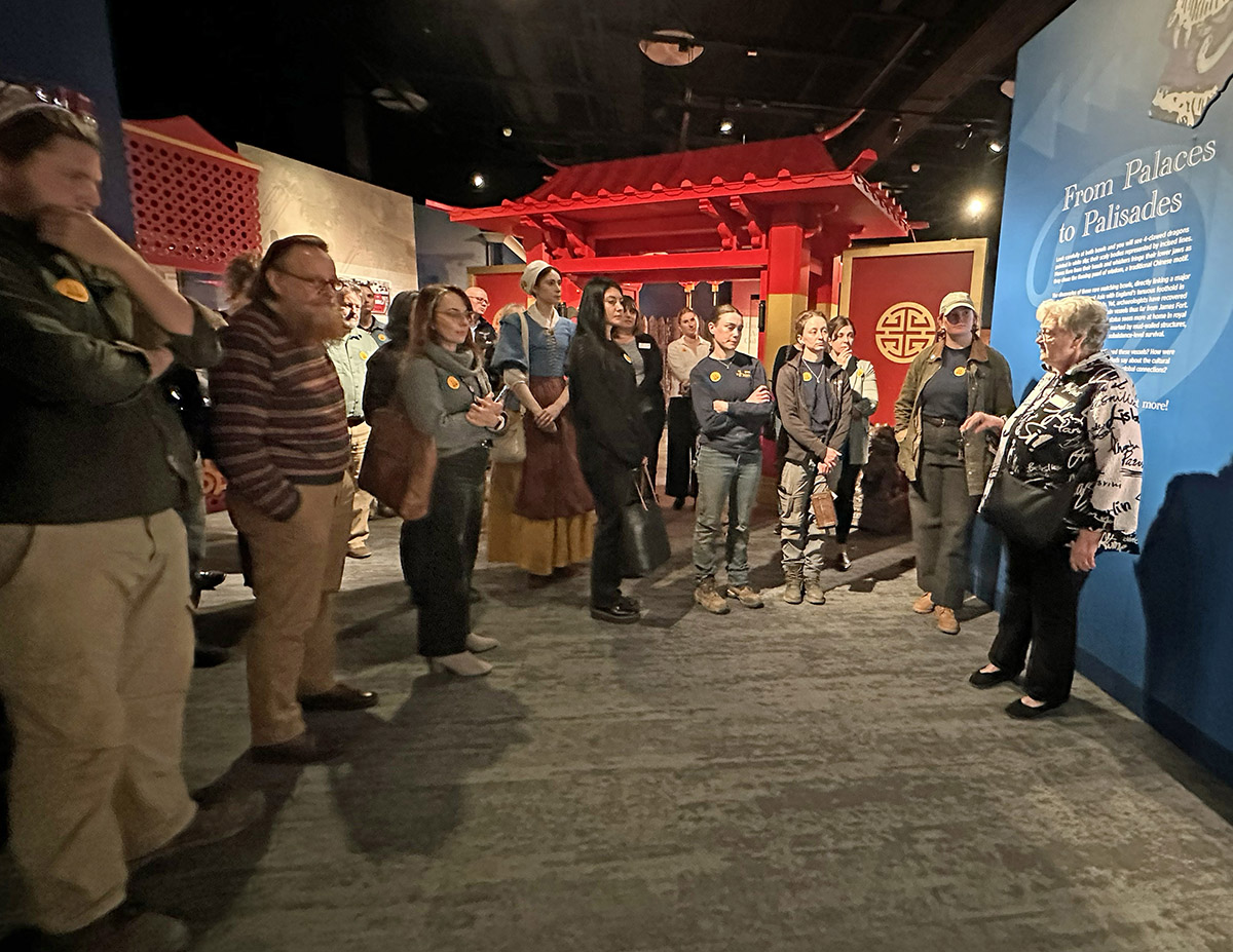 Jamestown Rediscovery Senior Curator Merry Outlaw gives a tour of the "Following the Dragon" exhibit to Jamestown Rediscovery staff.
