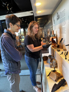 Dr. Umberto Veronesi and Senior Curator Leah Stricker examine a crucible in the Archaearium.