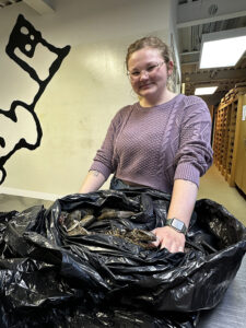 Assistant Curator Magen Hodapp with the iguana gifted by Jamestown Settlement.