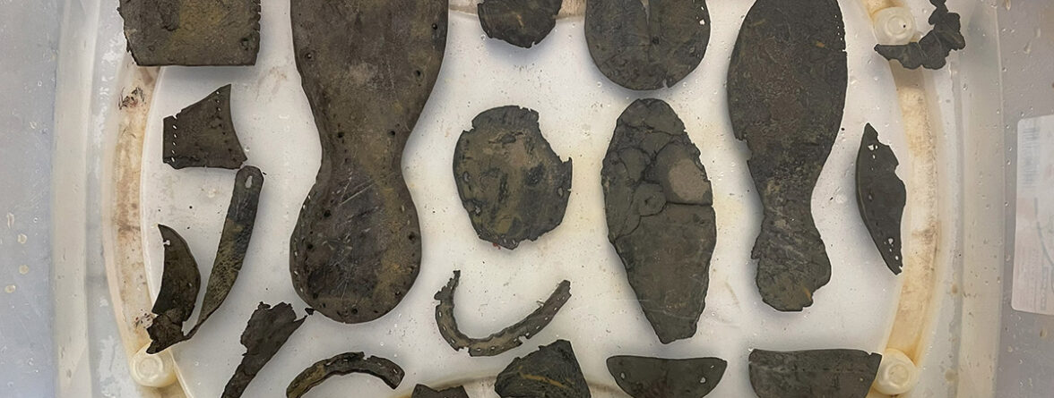 Leather shoe fragments excavated from the Governor's Well in water after excavation, fall 2023