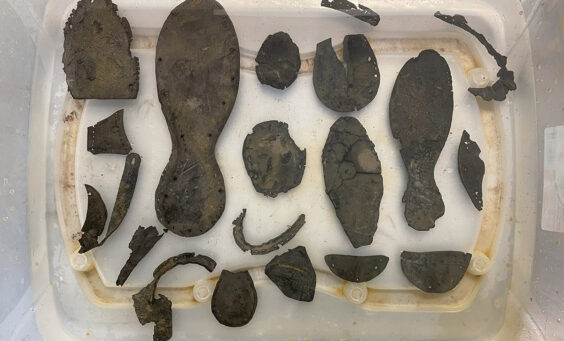 Leather shoe fragments excavated from the Governor's Well in water after excavation, fall 2023