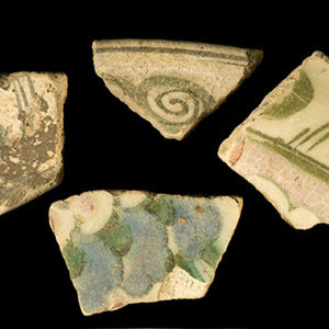 Four sherds of Iznik ware with green and blue handpainted decoration