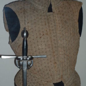 modern reproduction of a cloth-covered jack of plate and a sword