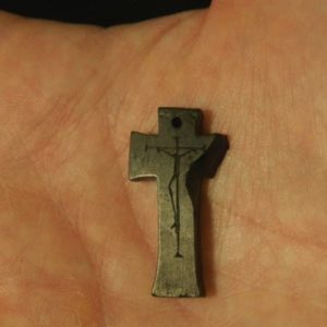 Hand holding small jet crucifix
