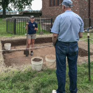 Archaeologist talks with visitor