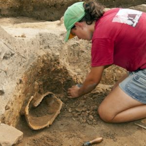 Archaeologist excavating a helment