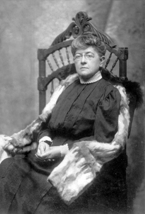 black and white photograph of a woman seated in a large chair