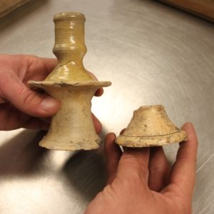 Earthenware candlestick and sherd