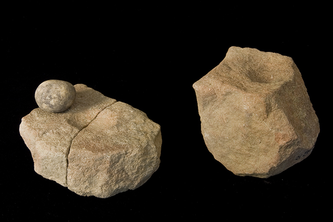 Two small sandstone blocks with indentation in the middle