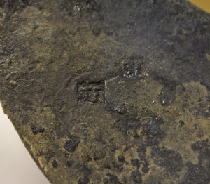 Close-up of square maker's marks on a hoe blade