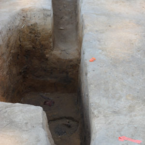Excavated oblong feature containing a posthole