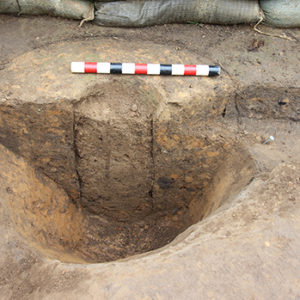 bisected posthole in the corner of an excavation unit
