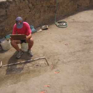 Seated student records measurements of excavated postmolds