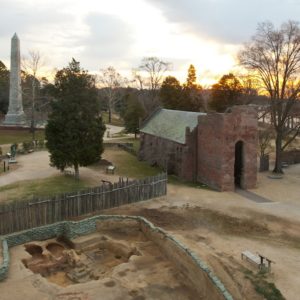 Sunrise over excavations and brick church