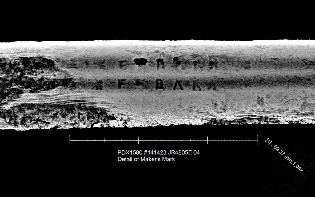 An edited x-ray image showing a detail of the maker's mark. Note that the bulbous concretion and overlying corrosion has been removed.