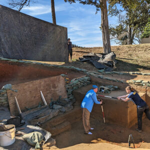 Senior Staff Archaeologist Dr. Chuck Durfor and Staff Archaeologist Natalie Reid prepare a portion of the Confederate moat for a record shot while Archaeological Field Technicians Josh Barber and Gabriel Brown provide shade.