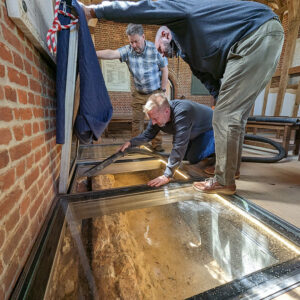 Conservator Dr. Chris Wilkins, Senior Conservator Dan Gamble and Director of Collections and Conservation Michael Lavin clean the early church foundations of bugs and spider webs.
